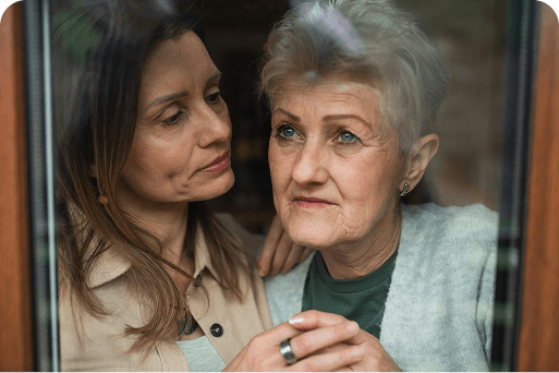 A granddaughter consoling her grandmother