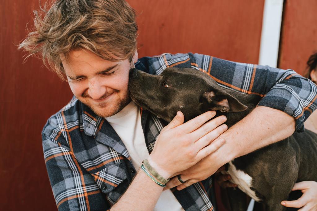 Man hugging dog