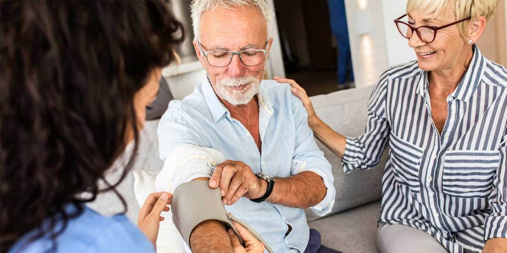 Man getting his blood pressure checked by a doctor