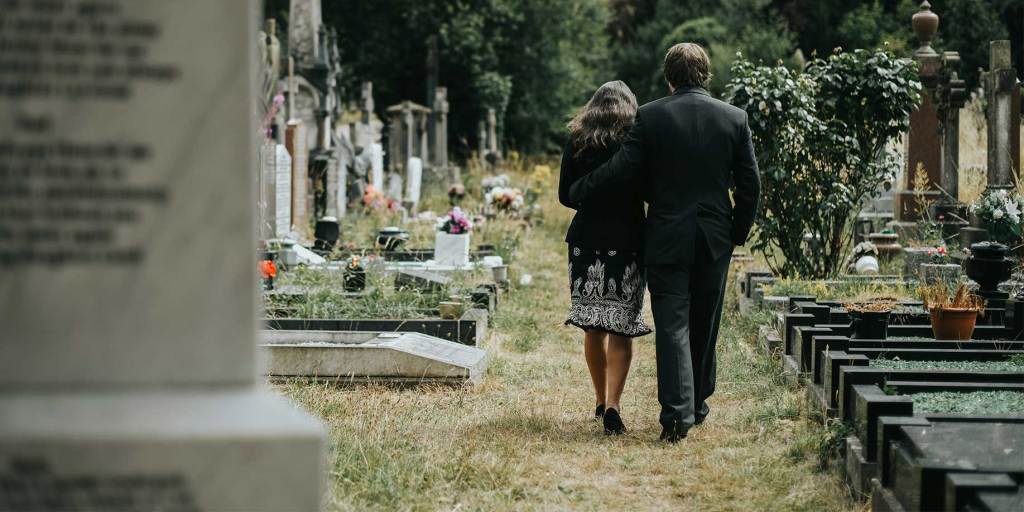 Mourners walking through a cemetary