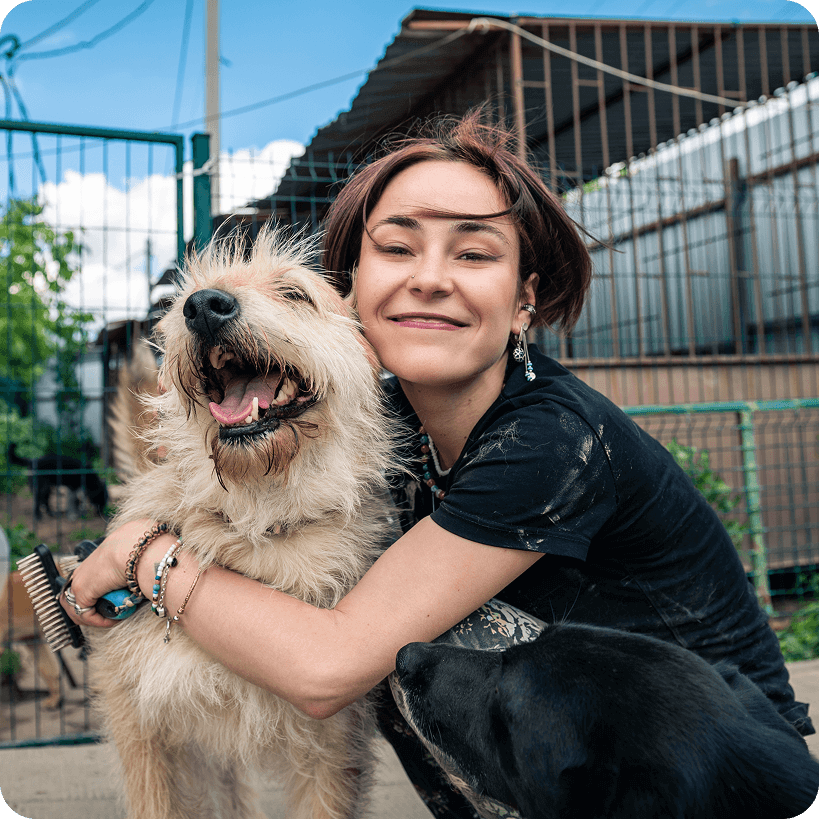 An owner hugging her dog