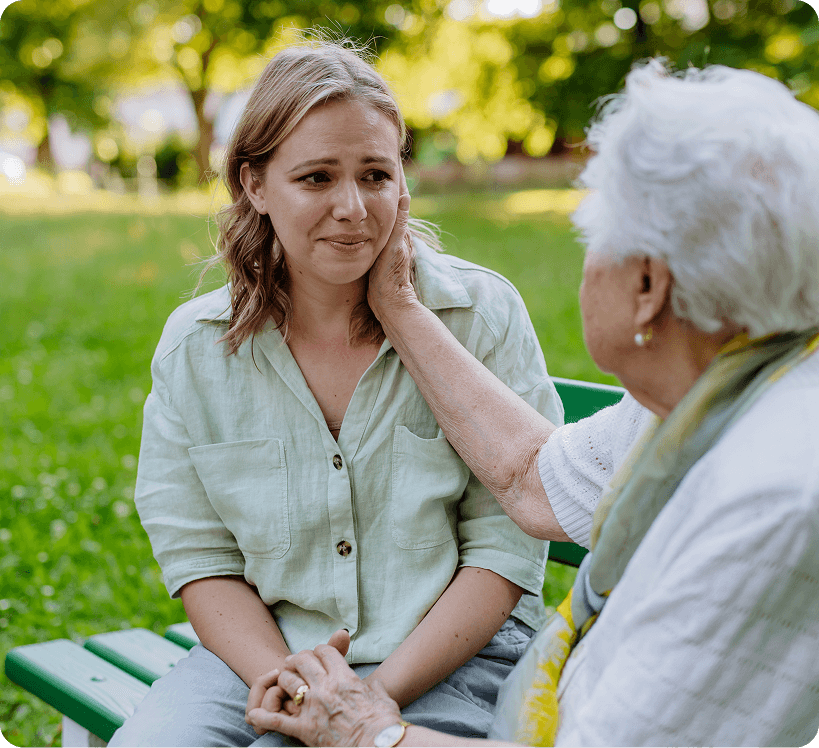 A grandmother consoling her granddaughter