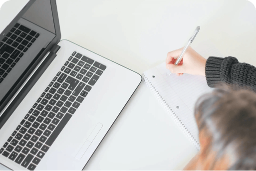 Person writing notes on a notepad