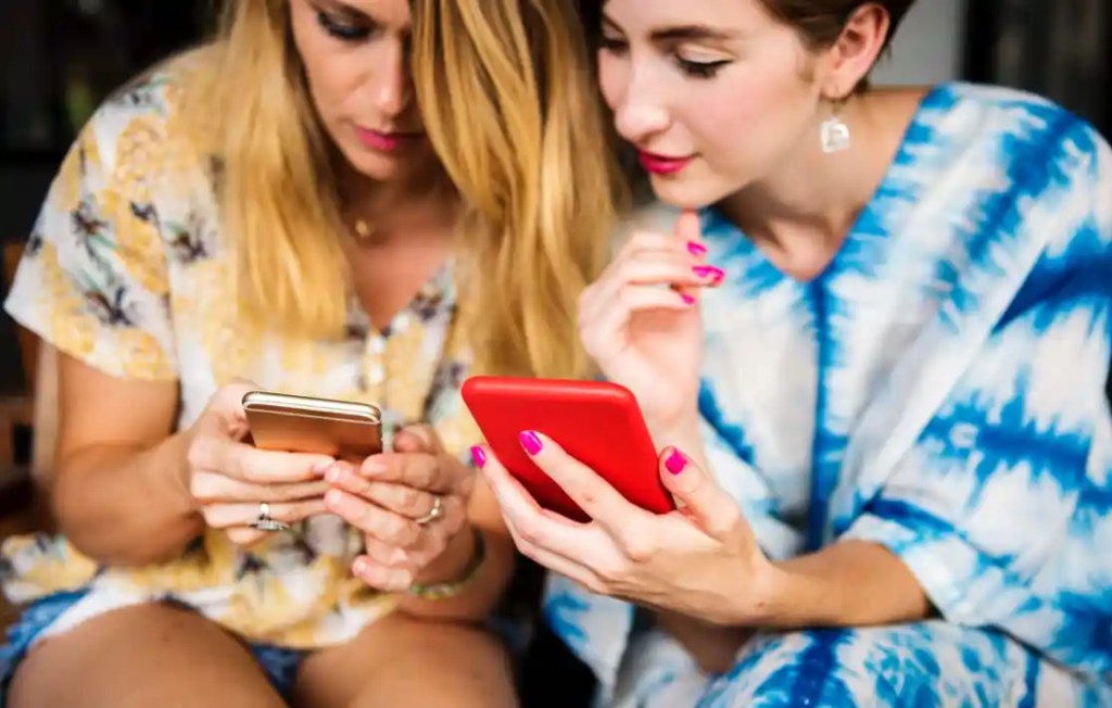 two people looking at a phone