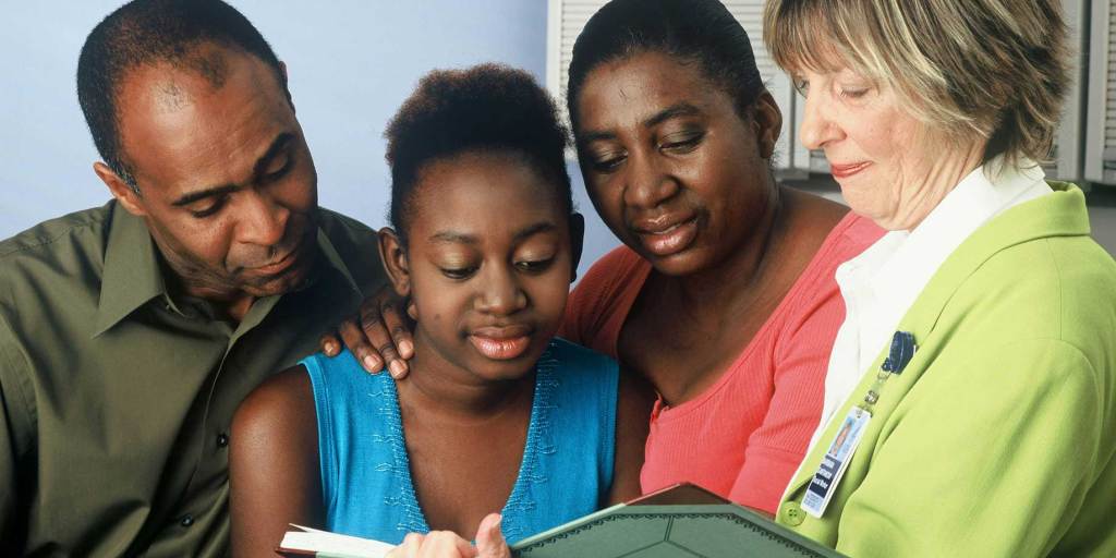 A family receiving care from a medical professional